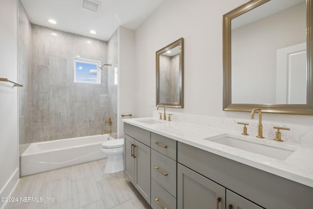 full bathroom with tiled shower / bath combo, toilet, and vanity