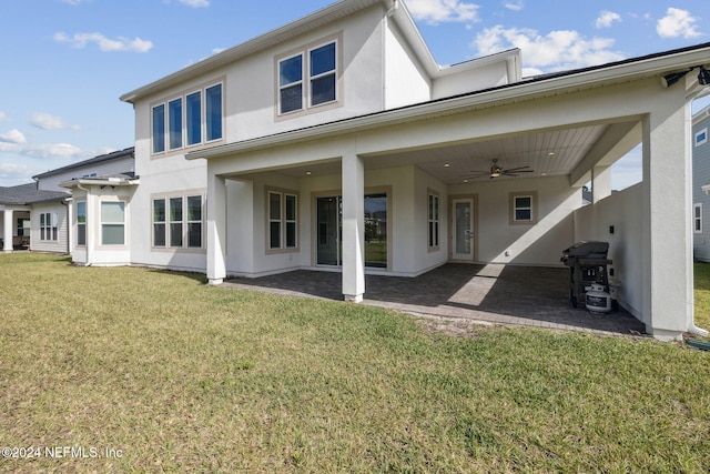 back of house featuring a lawn, a patio area, and ceiling fan