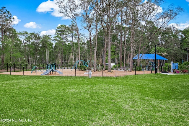 view of home's community featuring a lawn and a playground