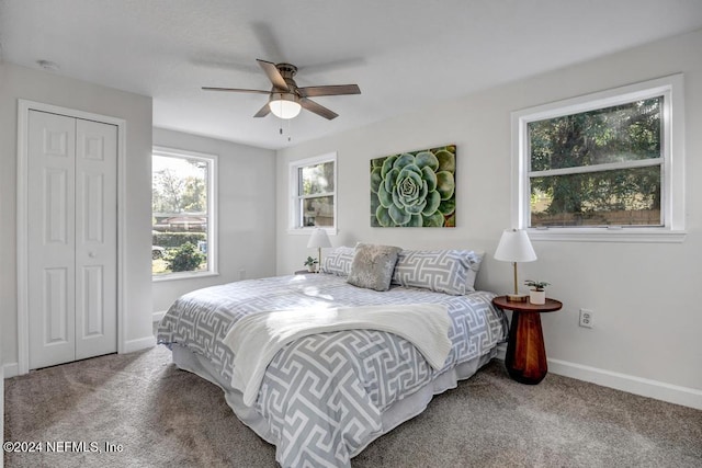 carpeted bedroom with ceiling fan and a closet