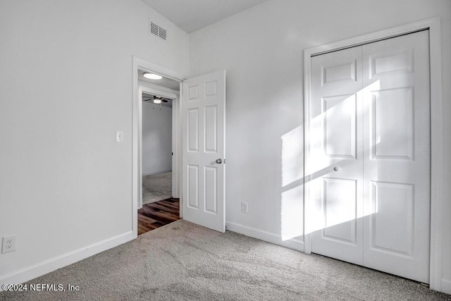 unfurnished bedroom with carpet flooring and a closet