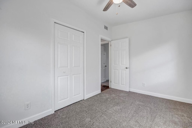 unfurnished bedroom with carpet flooring, ceiling fan, and a closet