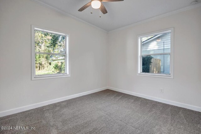 carpeted empty room featuring ceiling fan and ornamental molding