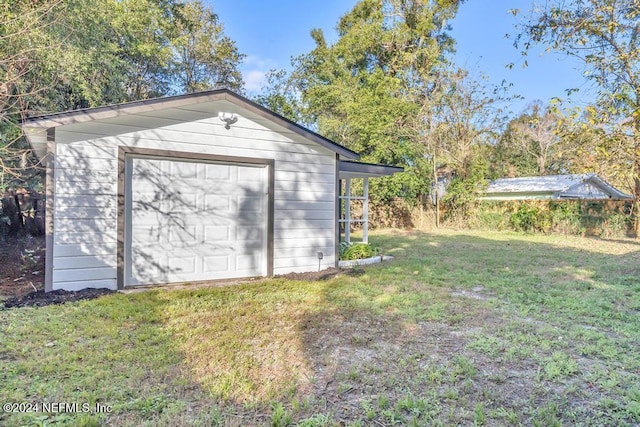 garage featuring a yard