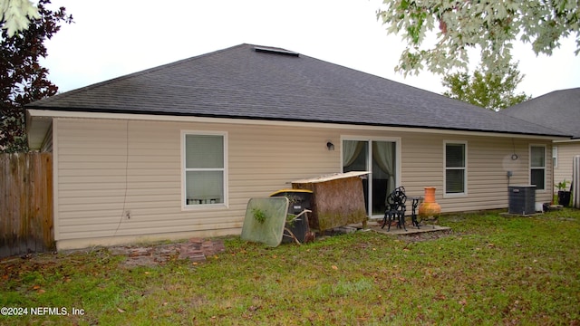 rear view of house featuring a yard and a patio