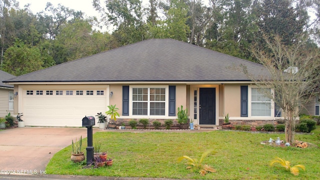 view of front of house with a front yard and a garage