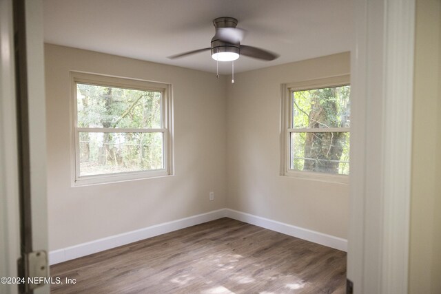 unfurnished room featuring hardwood / wood-style flooring, ceiling fan, and plenty of natural light