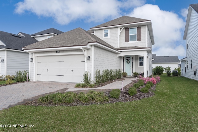 view of front facade with a garage and a front lawn