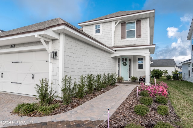 view of front of home featuring a garage and a front yard