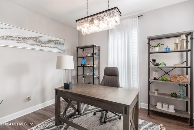 office with dark hardwood / wood-style flooring and a chandelier