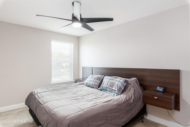 bedroom with ceiling fan and light colored carpet