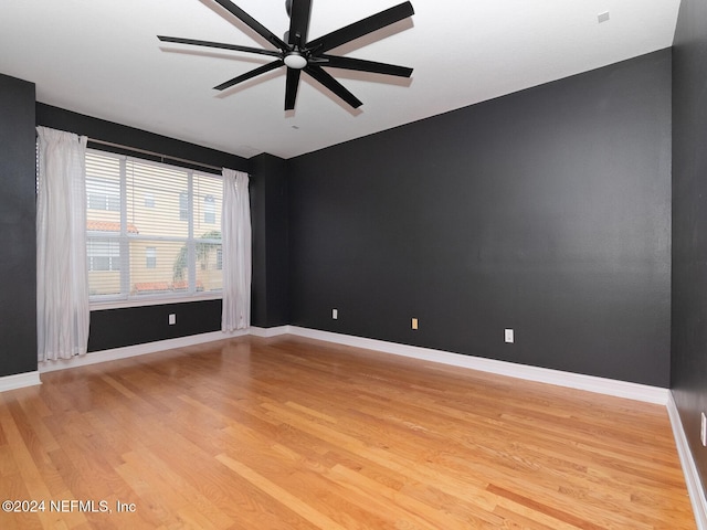 empty room featuring light wood-type flooring and ceiling fan