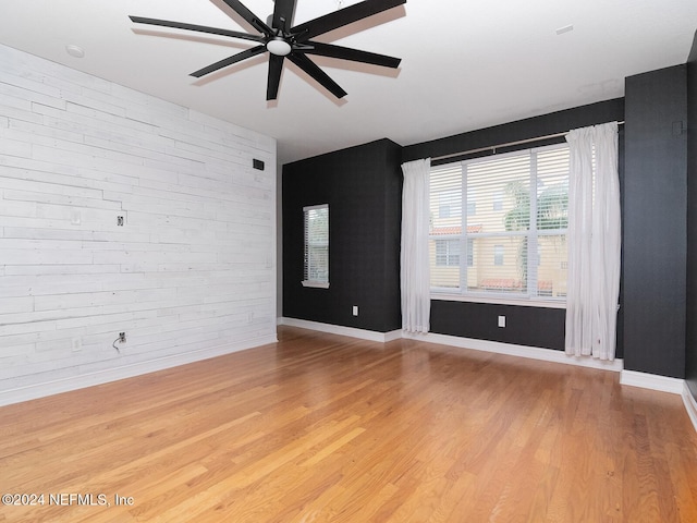 unfurnished room with hardwood / wood-style floors and ceiling fan