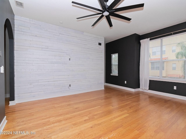 empty room with light wood-type flooring and ceiling fan