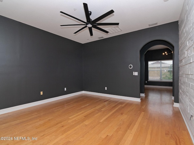 spare room with hardwood / wood-style flooring and ceiling fan