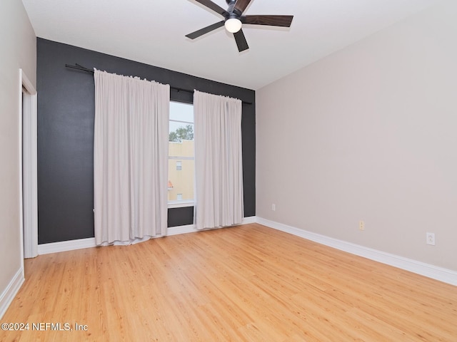 empty room featuring light wood-type flooring and ceiling fan