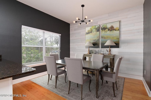 dining area featuring a notable chandelier and light hardwood / wood-style floors