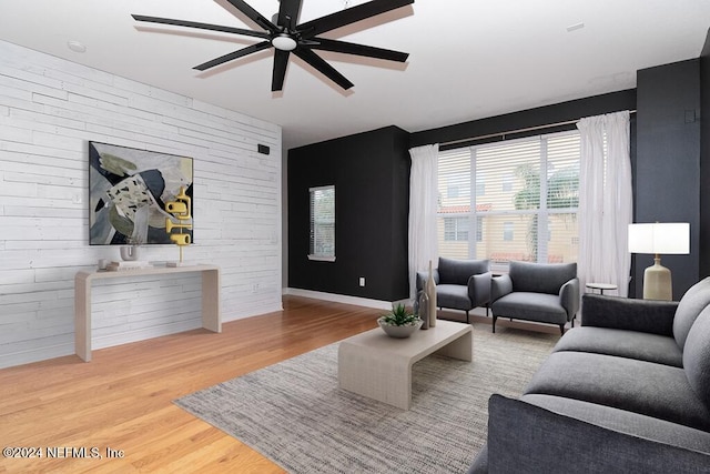 living room featuring wood-type flooring and ceiling fan