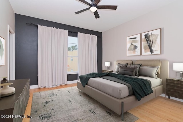 bedroom with light hardwood / wood-style floors and ceiling fan