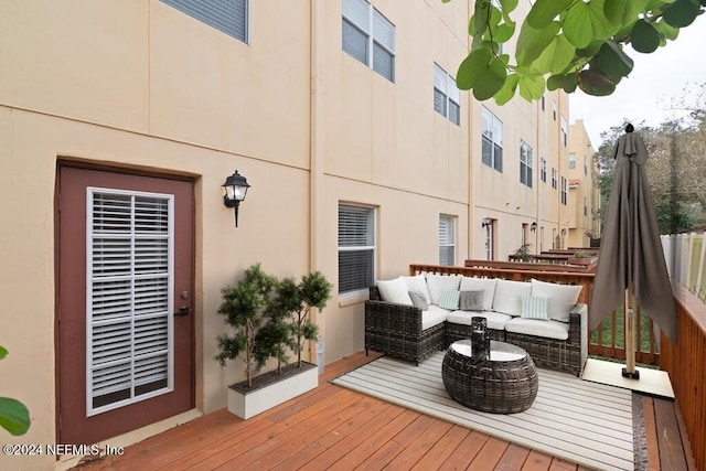 wooden terrace with an outdoor living space