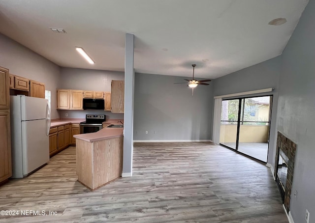 kitchen with white refrigerator, kitchen peninsula, stainless steel electric stove, light brown cabinets, and light hardwood / wood-style flooring