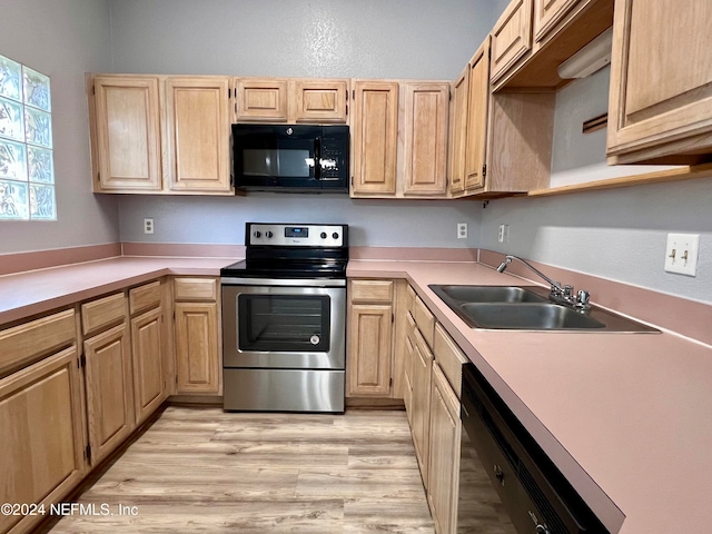 kitchen featuring light hardwood / wood-style floors, black appliances, sink, and light brown cabinetry