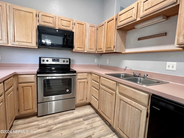 kitchen featuring black appliances, light brown cabinetry, light wood-type flooring, and sink