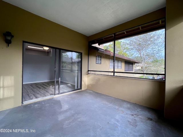 unfurnished sunroom with plenty of natural light