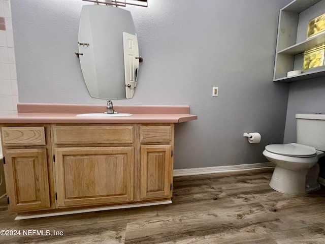 bathroom featuring hardwood / wood-style floors, vanity, and toilet