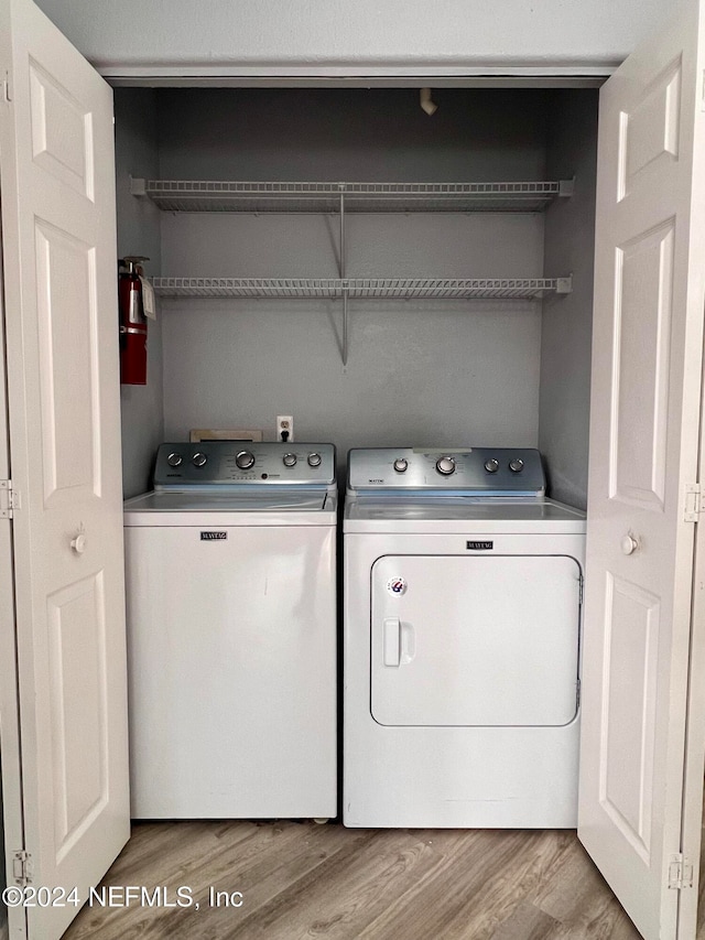 laundry room featuring light hardwood / wood-style floors and independent washer and dryer