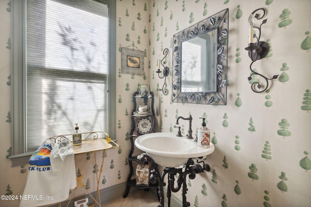 bathroom featuring tile patterned flooring, a healthy amount of sunlight, and sink