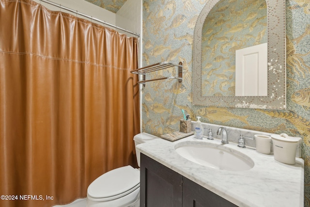 bathroom featuring toilet and vanity