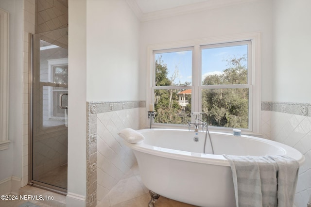 bathroom featuring tile walls, tile patterned flooring, separate shower and tub, and crown molding