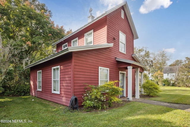 view of property exterior with a yard