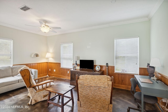 living room with ceiling fan, plenty of natural light, and ornamental molding