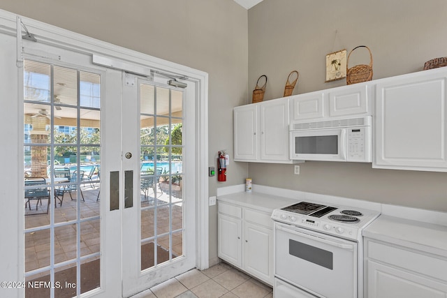 kitchen with white cabinetry, light tile patterned flooring, white appliances, and french doors