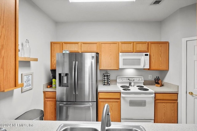 kitchen featuring sink and white appliances