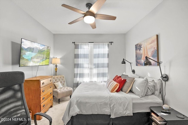 bedroom with ceiling fan and light carpet