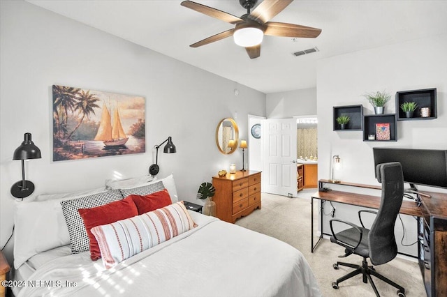 carpeted bedroom with ceiling fan and ensuite bath