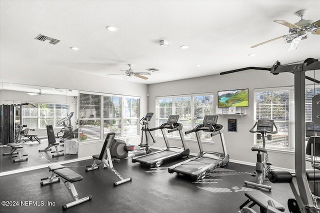 gym featuring plenty of natural light and a textured ceiling