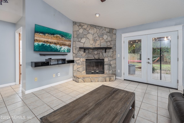 unfurnished living room with a fireplace, light tile patterned floors, and french doors