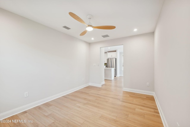 empty room featuring ceiling fan and light wood-type flooring