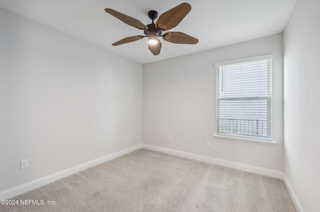 carpeted empty room featuring ceiling fan