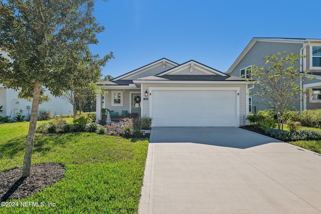 view of front of house featuring a garage and a front lawn