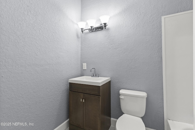 bathroom featuring toilet and vanity