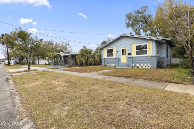 bungalow-style home with a front lawn