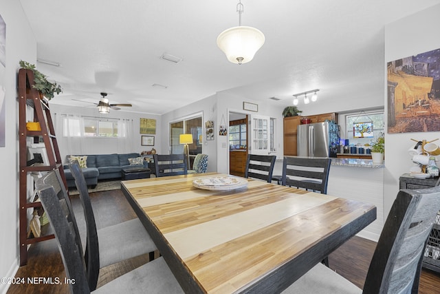 dining space with ceiling fan, wood-type flooring, and a textured ceiling