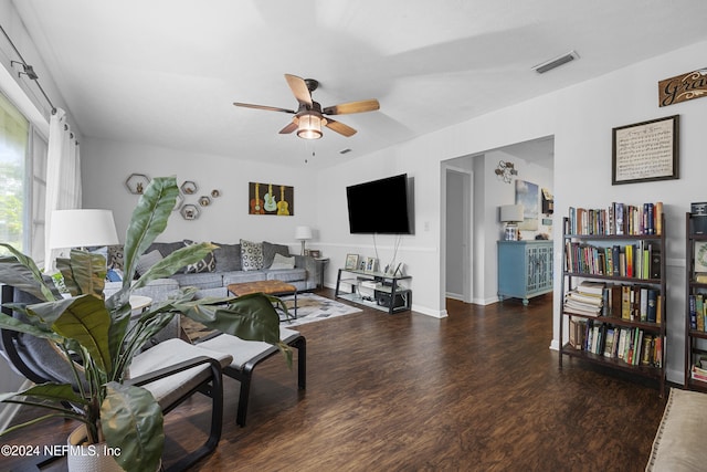 living room with ceiling fan and dark hardwood / wood-style floors