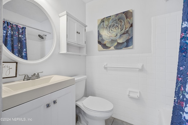 bathroom with toilet, tile walls, tile patterned flooring, curtained shower, and vanity