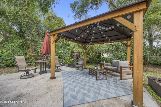 view of patio with an outdoor living space and a gazebo